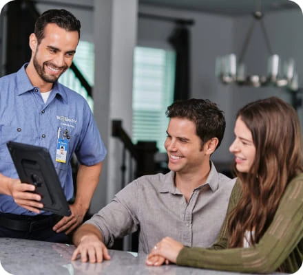 MRE service tech shows customers an ipad.